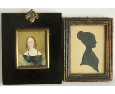 A mid-19th century portrait miniature in the naive style of a young woman in black dress, 6.5 x 5cm approx in black frame wit