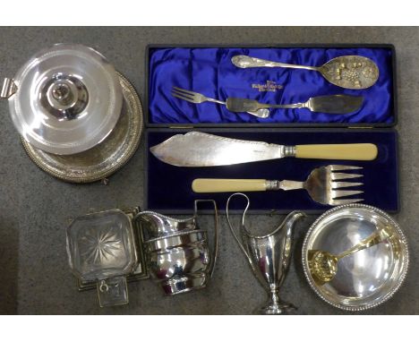 A collection of plated ware including a caddy, two early cream jugs, a pickle stand and cased fish servers by Walker &amp; Ha
