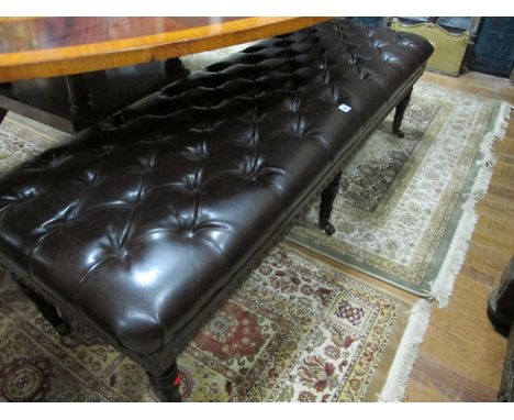 A GOOD GEORGIAN STYLE MAHOGANY AND HIDE UPHOLSTERED STOOL the rectangular seat with deep button upholstery raised on turned l