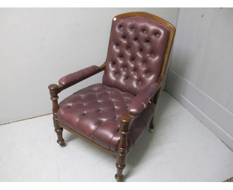 A GOOD EDWARDIAN MAHOGANY AND HIDE UPHOLSTERED LIBRARY CHAIR the rectangular arched back with deep button upholstered panel a