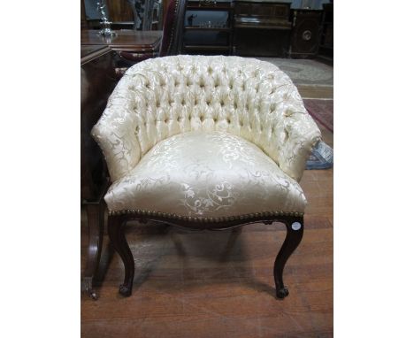 A MAHOGANY AND UPHOLSTERED TUB SHAPED BOUDOIR CHAIR the deep button upholstered back and seat on slender cabriole legs