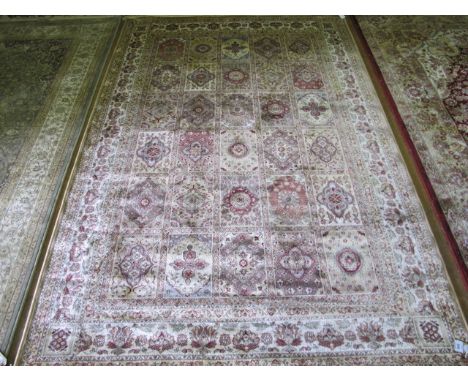 A WOOL RUG the beige light brown and green ground with panels filled with palmets within a floral border 236cm x 153cm
