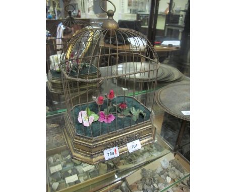 A CONTINENTAL GILTWOOD AND BRASS AUTOMATON BIRD GROUP IN CAGE
