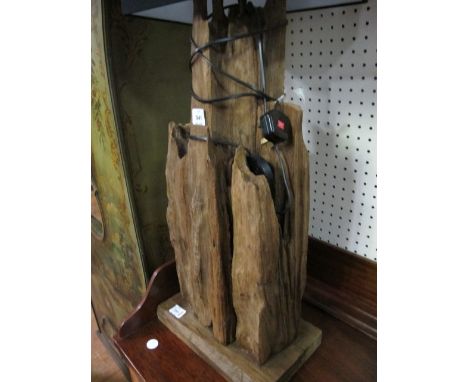 A DRIFTWOOD TABLE LAMP of irregular form raised on a moulded base 92cm high