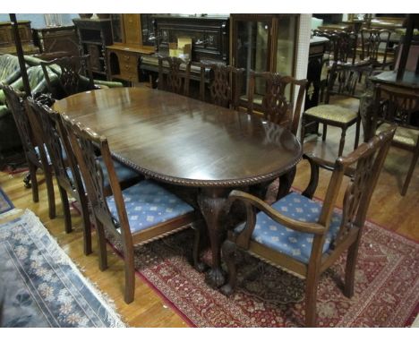 A NINE PIECE CHIPPENDALE STYLE MAHOGANY DINING SUITE comprising of eight chairs including a pair of elbow chairs each with a 