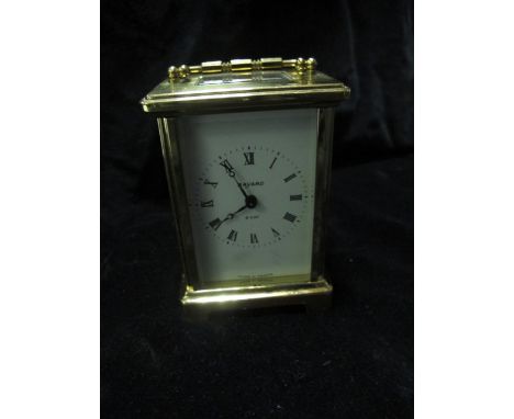 A FRENCH BRASS CARRIAGE CLOCK the rectangular enamel dial with Roman numerals raised on bracket feet 11cm high
