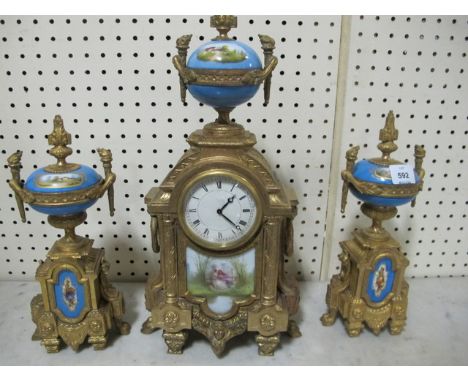 A FRENCH GILT BRASS AND PORCELAIN CLOCK GARNITURE 19th Century the rectangular arched case with enamel dial surmounted with a