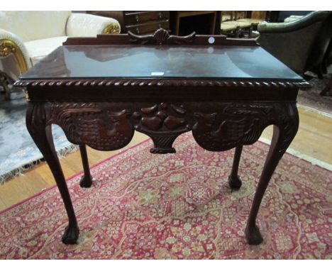 A CHIPPENDALE STYLE MAHOGANY SIDE TABLE the rectangular top with gadrooned rim above a carved frieze on cabriole legs with cl