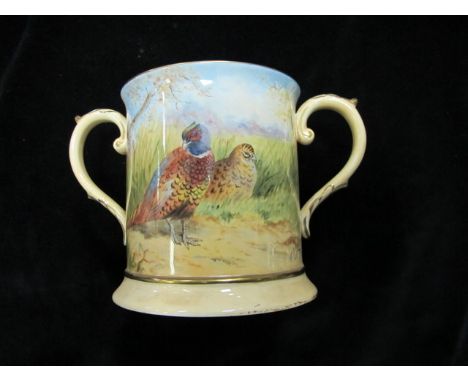 F CRANK A CHINA TWO HANDLED TANKARD the cream ground with painted panel depicting peacocks in a landscape with scroll handles