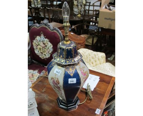 A CHINA TABLE LAMP of octagonal form the blue and white ground decorated with panels of exotic birds raised on a ebonised bas