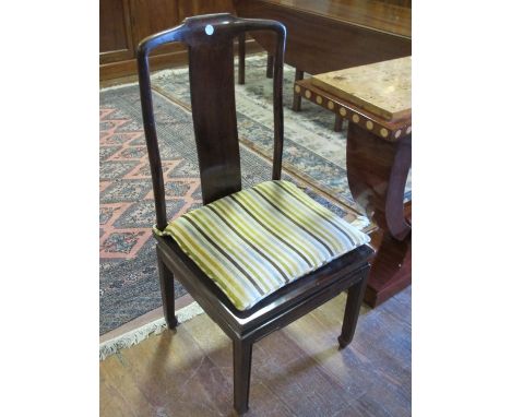 AN ORIENTAL HARDWOOD SIDE CHAIR the shaped top rail above a vertical splat and caned seat on loose cushion on moulded legs