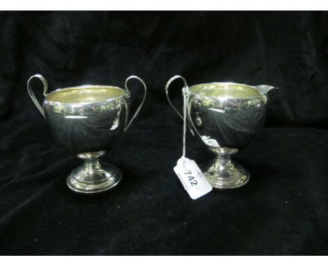 A STERLING SILVER TWO HANDLE CUP together with a sterling silver jug (2)