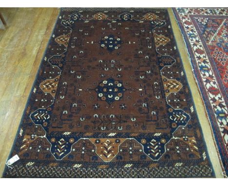 A BOKHARA WOOL RUG the light brown and indigo ground with stylized flowerheads within a three strand conforming border 183cm 