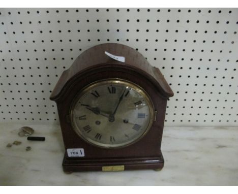 A MAHOGANY CASED MANTLE CLOCK the rectangular arched dial with silver dial and Roman numerals raised on brass bun feet 28cm h