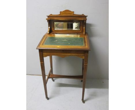 AN EDWARDIAN MAHOGANY AND SATINWOOD CROSS BANDED DESK the super structure with moulded shelf above a bevelled glass mirror an