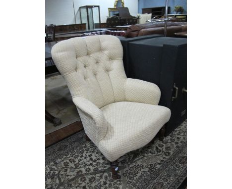 A BEECHWOOD AND UPHOLSTERED EASY CHAIR with deep button upholstered back and seat on turned legs