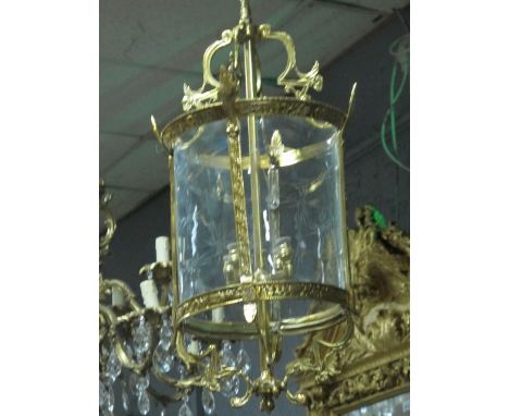 A GILT BRASS AND ENGRAVED GLASS FOUR LIGHT HALL LANTERN of cylindrical form and engraved glass panels 98cm drop