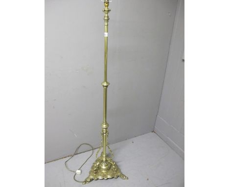 A VICTORIAN BRASS TELESCOPIC FLOOR STANDARD LAMP the cylindrical column raised on a pierced shaped platform with foliate and 