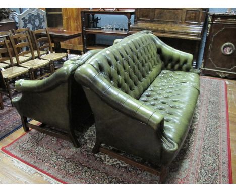 A GREEN THREE PIECE HIDE UPHOLSTERED LIBRARY SUITE to include two couches and a chair with deep button upholstered back and s