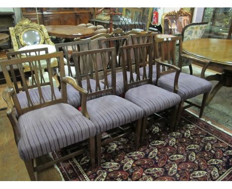 A SET OF EIGHT MAHOGANY FORK BACK DINING CHAIRS including a pair of elbow chairs each with an uphosltered seat on square tape