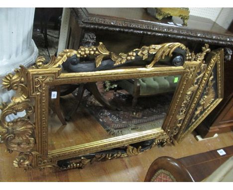 A FINE CONTINENTAL GILTWOOD AND GESSO ARCHITECTURAL MIRROR the rectangular plate within an egg and dart border frame with she