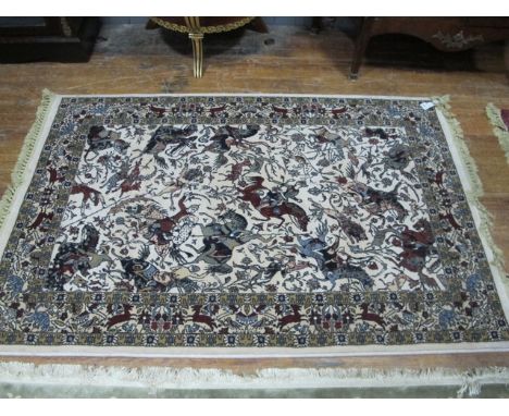 A WOOL RUG the beige ground with central panel depicting warriors within a foliate border with birds 186cm x 120cm