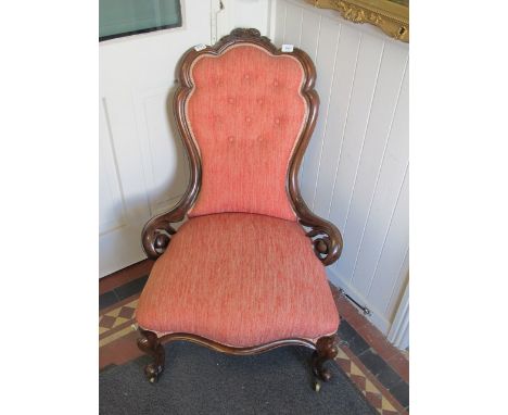A VICTORIAN WALNUT LADIES CHAIR the foliate and flowerhead carved cresting above a button upholstered back and seat on cabrio