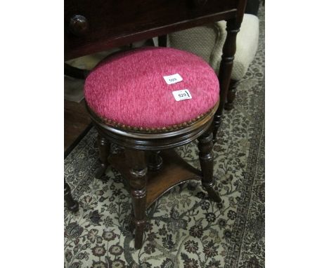 AN EDWARDIAN MAHOGANY STOOL the circular upholstered seat raised on turned legs joined by an under tier 53cm high