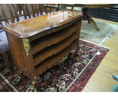 A CONTINENTAL WALNUT OPEN FRONT SHELF of rectangular serpentine outline the shaped moulded top above three open shelves on ca