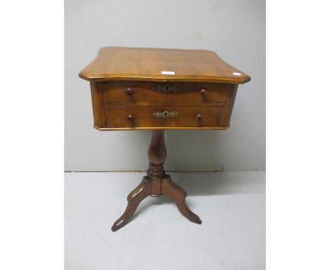 A CONTINENTAL WALNUT TABLE of serpentine outline the shaped moulded top above two frieze drawers above a baluster column on t