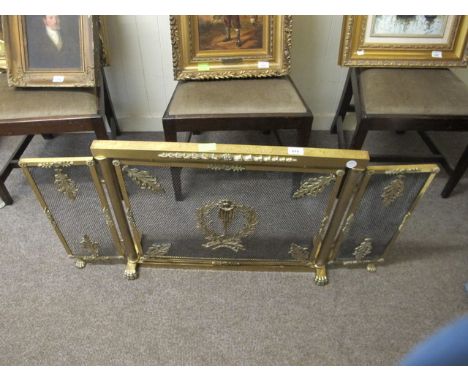 A BRASS AND MESH THREE FOLD FIRESCREEN with applied foliate decoration raised on claw feet 58cm x 112cm
