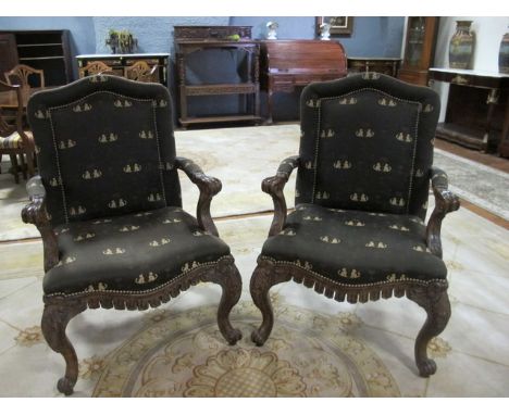 A PAIR OF CONTINENTAL BEECHWOOD AND UPHOLSTERED ARMCHAIRS each with a rectangular arched back with upholstered panel and seat