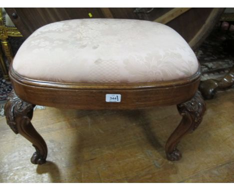 A CHIPPENDALE STYLE MAHOGANY STOOL the oval upholstered seat above a plain apron on cabriole legs with scroll toes with carve