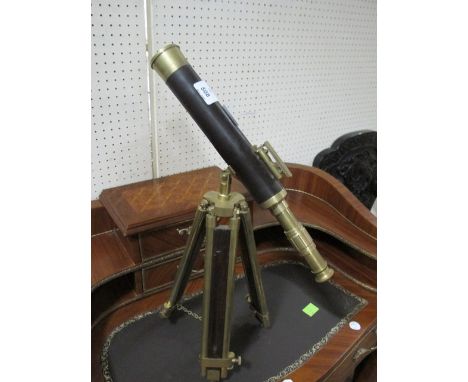 A BRASS AND LEATHER BOUND TABLE TOP TELESCOPE raised on telescopic tripod support telescope 43cm long