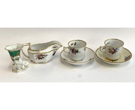 A pair of a Spode teacups and saucers, pattern no. 2527, together with a matching gravy boat and an unmarked porcelain cornuc