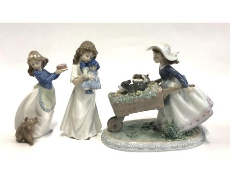 A Lladro figurine, no. 5460, girl with two puppies in a wheelbarrow, together with two Nao figures (3) 