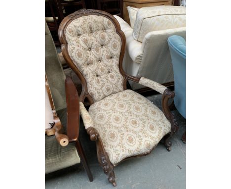 A Victorian carved walnut button back bedroom chair on casters