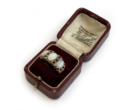 A heavy 9ct gold ring set with opals and garnets, size M 1/2, approx. 6.3g, in an antique ring box 