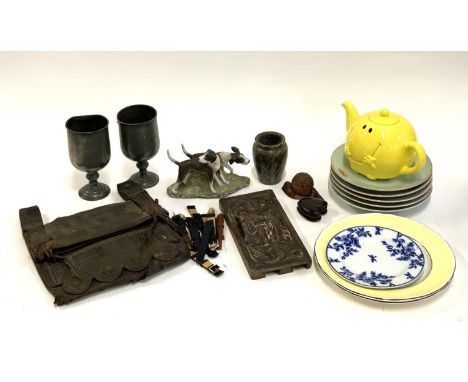 A mixed lot to include pewter goblets, Mr Happy teapot, crab plates, carved wooden drawer front, African tribal leather bag, 