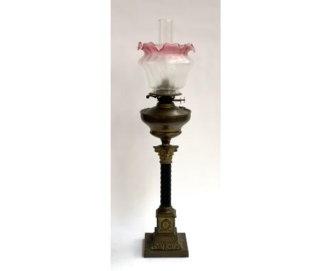 A brass oil lamp with glass chimney and shade, Corinthian capital on square set base, 80cmH to top of chimney 