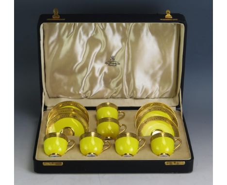 A Royal Worcester six setting coffee service, the yellow ground with gilded decoration, contained in a fitted case, (one sauc