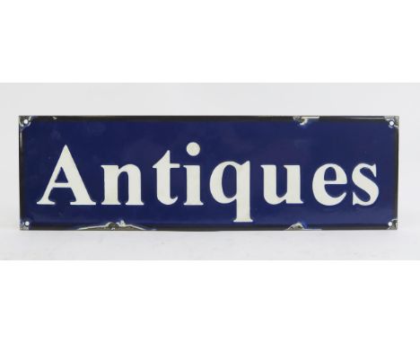 A reproduction enamel advertising sign 'Antiques', 15 x 51cm.