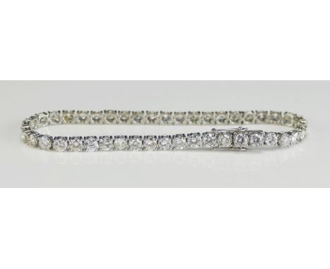 A Platinum and Diamond Tennis Bracelet set with 34 c. 3.t6mm brilliant round cuts weighing c. 8ct, 19cm (7.5"), stamped Pt950