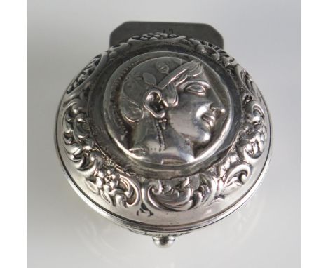 A white metal snuff box, of circular form, the lid decorated with a classical scene the base with an Athenian owl, 5.5cm diam