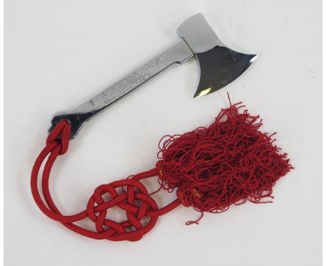 A Japanese polished steel ceremonial axe, for use on launching ships,  with red knotted cord. 22cm long