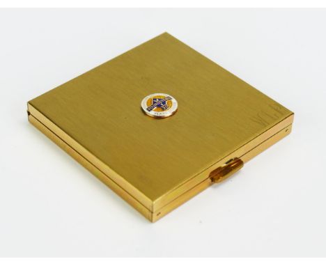 A Volupte gilt metal powder compact of square outline with enamel long service badge. 