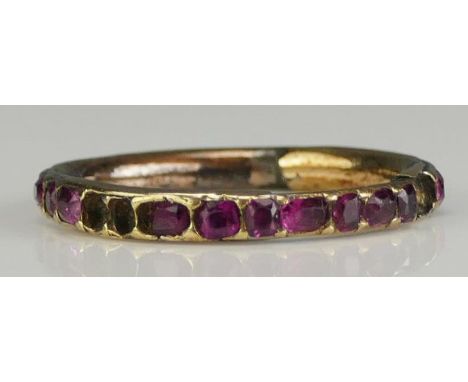 A Georgian Ruby Eternity Ring in a yellow metal setting, size K, 1.4g. Missing stones and faults