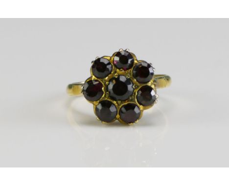 A 9ct Gold and Garnet Cluster Ring, 13mm head, size L.25, stamped 9CT, 3.11g