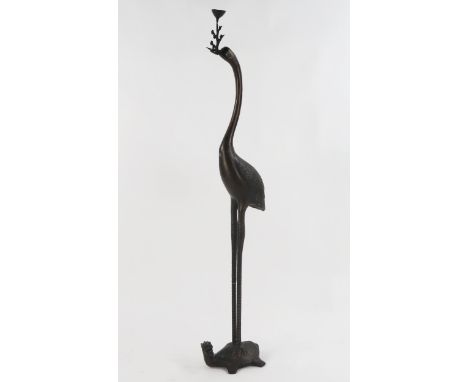 A bronze pricket candlestick modelled as a crane standing on a turtle, 118cm.