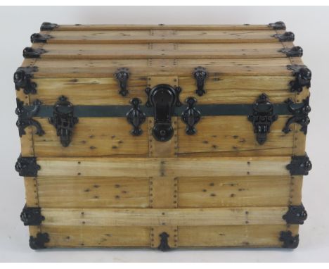 A beech and metal bound trunk of rectangular outline with hinged lid, and leather carrying handles to the side, 78cm wide, 55